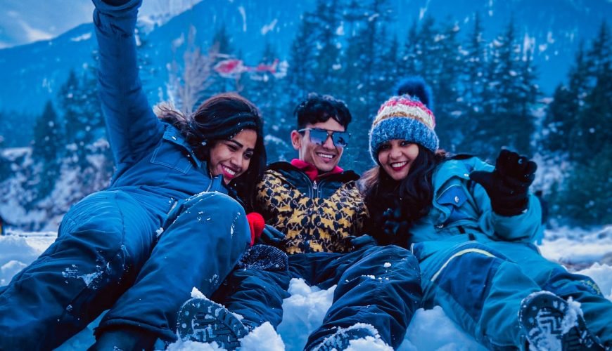 Himachal Tour Packages - Scenic Views of Mountains and women enjoying in Snow